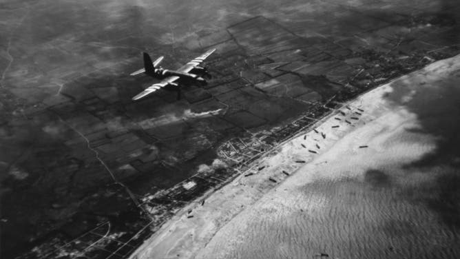 A Ninth Air Force B-26 flies over one of the beaches during the invasion of Normandy in June 1944. (Photo by Jeffrey Markowitz/Sygma via Getty Images)