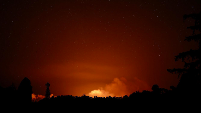 Kīlauea's eruption plume illuminated during the early morning hours of June 3, 2024, visible from the Volcano Golf Course area. USGS image by D.A. Phillips.