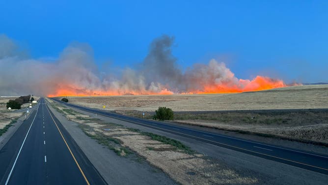 Bright orange flames from the Corral Fire can been seen near I-580 in Tracy, California on Saturday, June 1, 2024.