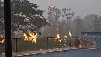 Pool fence erupts in sparks as lightning strikes nearby tree - Fox News