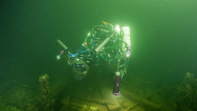 Diver investigating the shipwreck.