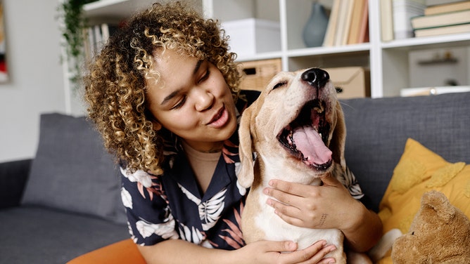 Girl loving her adorable dog