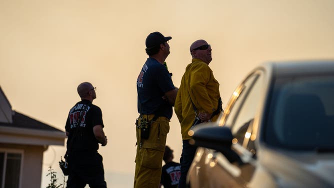 Emergency crews are seen assessing the situation as the Sandhurst Fire burns outside Salt Lake City on Saturday, July 20, 2024.