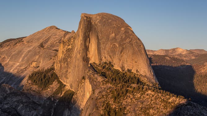 YOSEMITE VALLEY, CA - OCTOBER 05: The iconic Half Dome is viewed from Glacier Point at sunset on October 5, 2019, in Yosemite National Park, California. With the arrival of fall, the tens of thousands of monthly visitors begins to drop off but the usual weekend traffic congestion and on-going road construction projects continue to provide challenges for getting around in the Park. (Photo by George Rose/Getty Images)