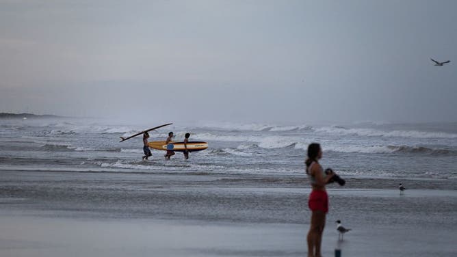 Surfers on North Padre Island ahead of Hurricane Beryl's landfall in Corpus Christi, Texas, US, on Sunday, July 7, 2024.