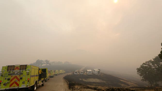 Firefighters gather along Figueroa Mountain