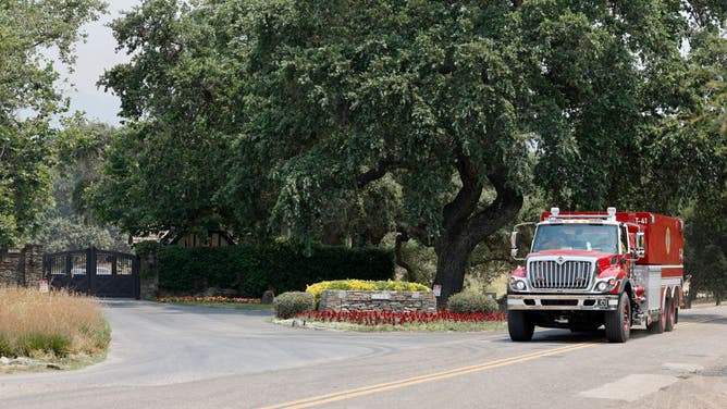 Smoke hangs around the entrance to Neverland Ranch
