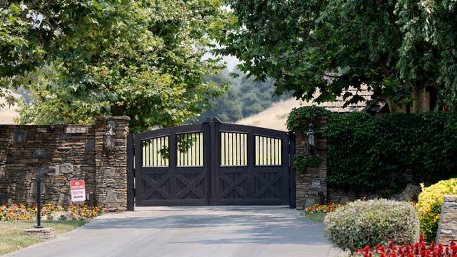 Smoke hangs around the entrance to Neverland Ranch