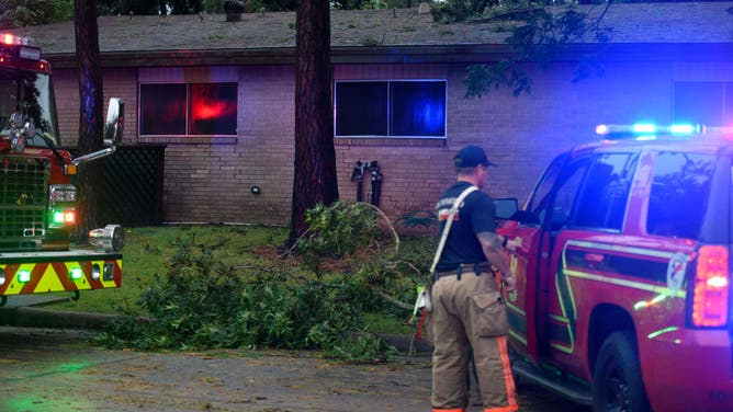 Firefighters check on a house in Rosenberg, Texas, on July 8, 2024.