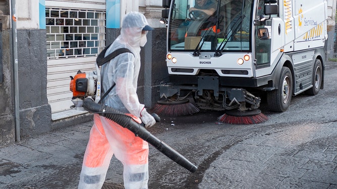 A cleaner cleaning pavements from the volcanic ash that fell during the volcano's paroxysmal phase on July 05, 2024 in Catania, Italy.