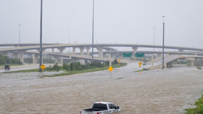 A vehicle is left abandoned in floodwater on a highway after Hurricane Beryl swept through the area on July 08, 2024 in Houston, Texas.