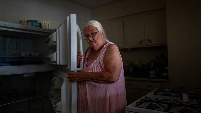 Lily Reeds, 72, shows her empty refrigerator in her apartment in the Kashmere Gardens neighborhood on July 11, 2024 in Houston, Texas.