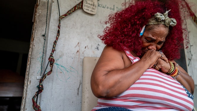 Menifee Lucy, 60, sits on her front porch for air in the Kashmere Gardens neighborhood on July 11, 2024 in Houston, Texas.