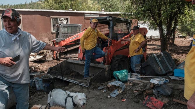 Beatrice Parraz cleans up in the Cherokee Mobile Village after flooding from rain storms hit the the Salt Fire burn scar on July 16, 2024 in Ruidoso, NM.