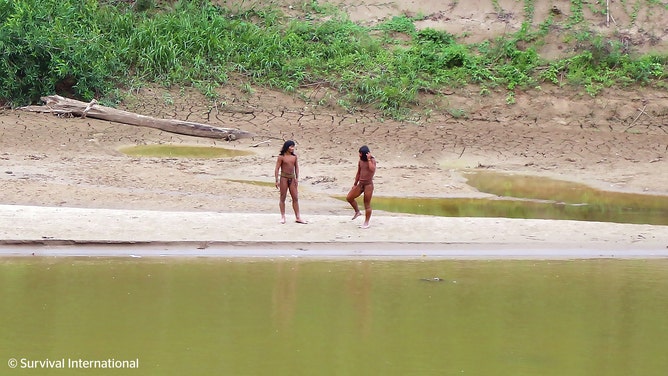 A photo shared by the indigenous rights group Survival International shows dozens of people from the Mashco Piro tribe recently seen on a riverbank near Monte Salvado — a village of the Yine people – in southeast Peru.