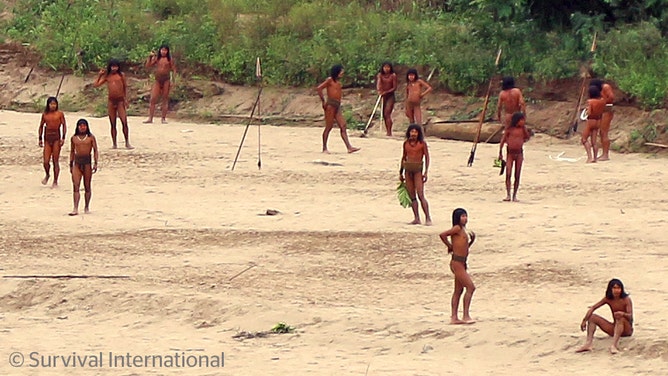 A photo shared by the indigenous rights group Survival International shows dozens of people from the Mashco Piro tribe recently seen on a riverbank near Monte Salvado — a village of the Yine people – in southeast Peru.