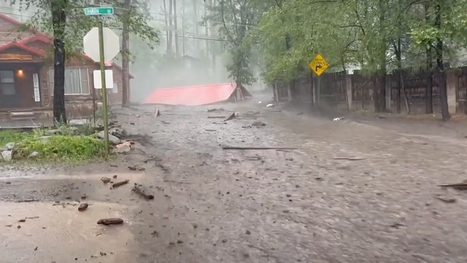 The roof of a garage seen as flood water carry away the building in Ruidoso, New Mexico on July 9, 2024.