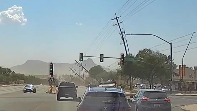 Electric poles fall over and onto the street. 