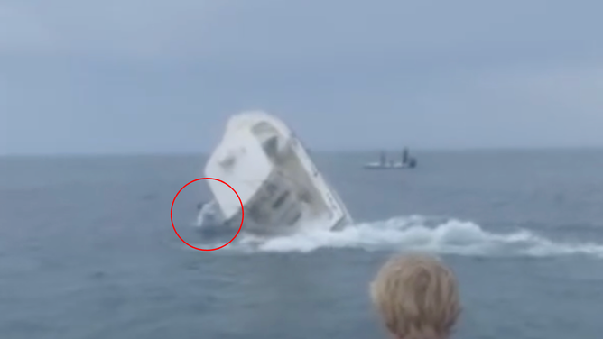 An individual appearing to fall out of the boat is circled in red.