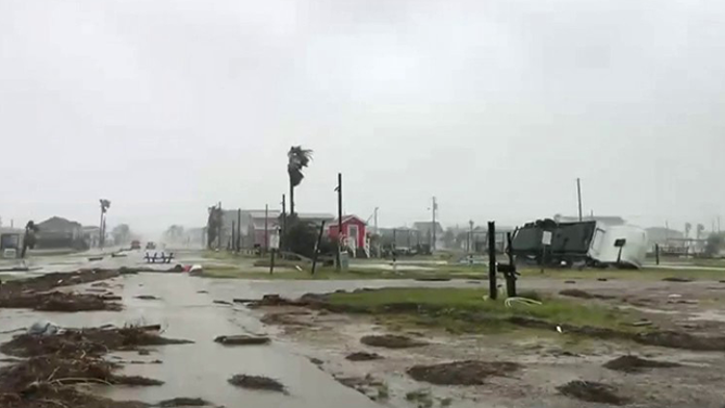 This image shows an RV on its side and debris in the road in Surfside Beach, Texas, after Hurricane Beryl made landfall on Monday, July 8, 2024.