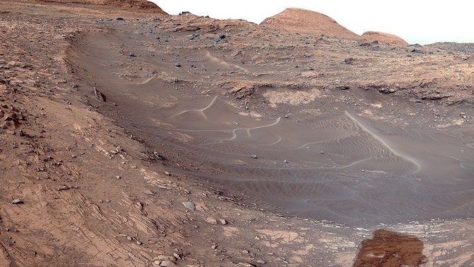 Curiosity Mars rover captured this view of Gediz Vallis channel on March 31. This area was likely formed by large floods of water and debris that piled jumbles of rocks into mounds within the channel.