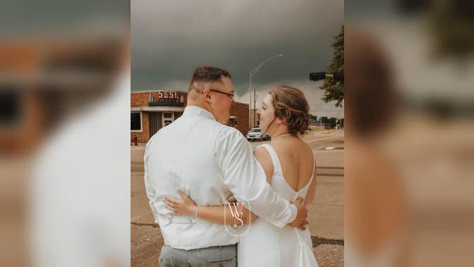 A funnel cloud forming behind a newlywed couple in Northfolk, Nebraska on July 20, 2024.