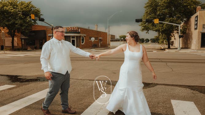 A funnel cloud forming behind a newlywed couple in Northfolk, Nebraska on July 20, 2024.