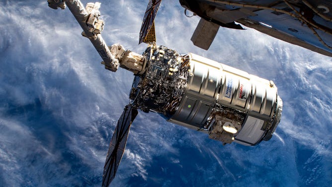 Northrop Grumman's Cygnus spacecraft is attached to the Canadarm2 robotic arm about to be released into Earth orbit ending a five-and-a-half month cargo mission berthed to the International Space Station's Unity module.