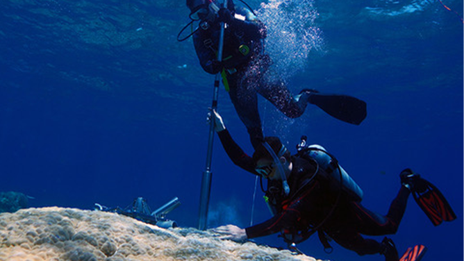 Scientists drill for coral samples along the Great Barrier Reef in Australia.