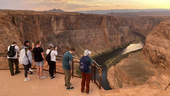 FILE: Visitors looking out onto Horseshoe Bend.