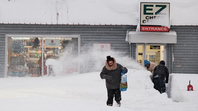 A resident leaves a local corner store in Buffalo, New York, on December 26, 2022, as many major grocery stores remained closed.