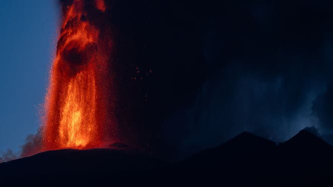 Lava spews from a crater of the Mount Etna volcano early on August 4, 2024 in Sicily. 