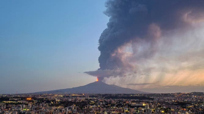 An aerial view at dawn of Mount Etna's spectacular eruption seen from the city of Catania on August 04, 2024 in Catania, Italy. Mount Etna's latest eruption spewed kilometre-high fountains of lava from the Voragine crater as the wind blew east-northeast spreading ash emissions on the villages on the north-eastern slope.