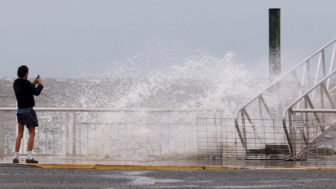 A wave crashes ashore as the region prepares for the arrival of Hurricane Debby, which is strengthening as it moves through the Gulf of Mexico on Sunday in Cedar Key, Florida.