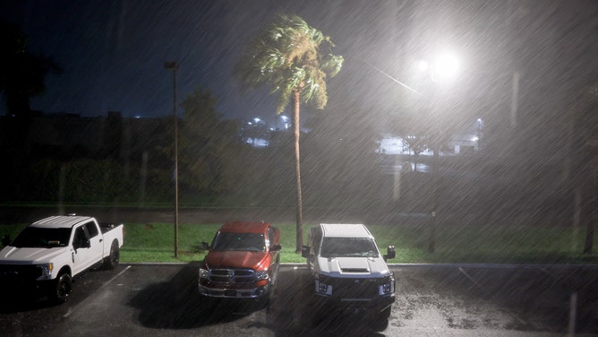 Wind and rain kicked up by Hurricane Debby blow through a hotel parking lot on Monday in Chiefland, Florida.