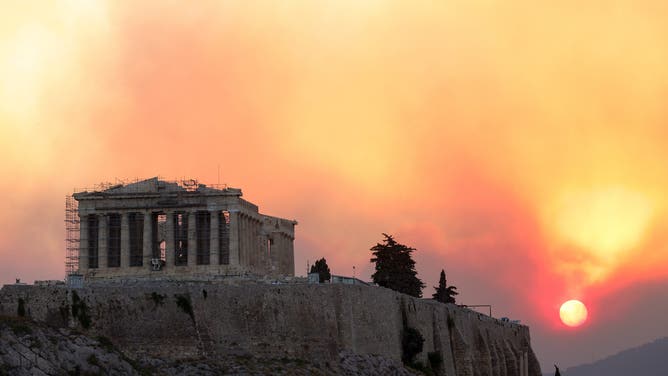 ATHENS, GREECE – AUGUST 12: Smoke rises over the Parthenon temple during a forest fire near Athens, Greece, August 12, 2024. (Photo by Costas Baltas/Anadolu via Getty Images)