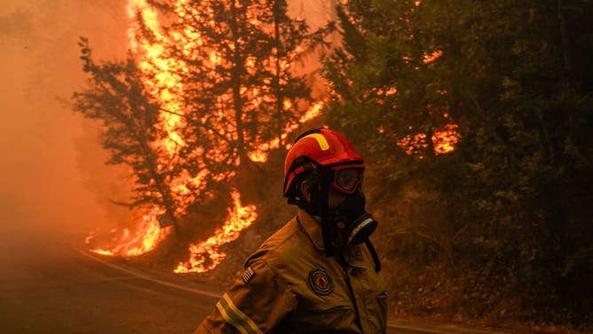 A firefighter battles as he battles the East Attica wildfire in Varnavas, northeast of Athens, Greece, Sunday, Aug. 11, 2024. Several wildfires broke out in Greece on Sunday, including in areas near the capital. Red alerts have been declared in large parts of the country. Photographer: Nick Paleologos/Bloomberg via Getty Images