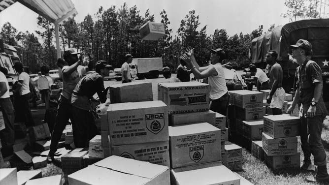 FILE - Members of the Georgia National Guard unload food donated by the US Department of Agriculture for distribution to those affected by Hurricane Camille, Biloxi, Mississippi, August 1969. More than 2 million pounds of food has been made available to relief agencies working in areas destroyed by Camille, a category 5 hurricane that hit parts of Alabama, Mississippi and Louisiana on the Gulf Coast on the 17th and 18th of August 1969. (Photo by Hulton Archive/Getty Images)