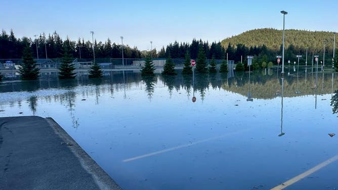 FILE - This photo shows a flooded parking lot in Alaska after glacial lake outburst flooding.
