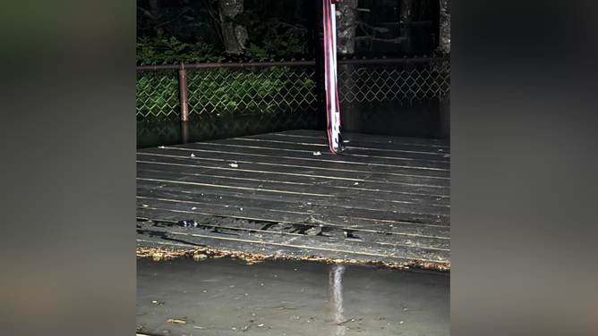 The river beginning to overtake the fence and deck.