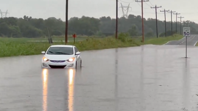 A car in floodwaters in Norman, Oklahoma at Tecumseh and NE 24th Street on Aug. 11, 2024.