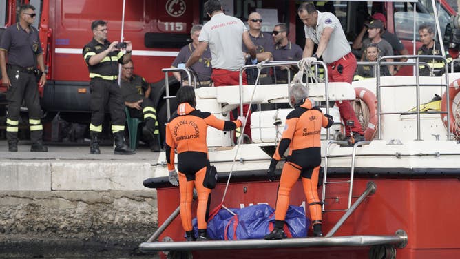 Rescue divers deliver a fifth body bag to the shore after recovery from the luxury yacht Bayesian which sank off the coast of Porticello, Sicily, on Wednesday, Aug. 21, 2024.