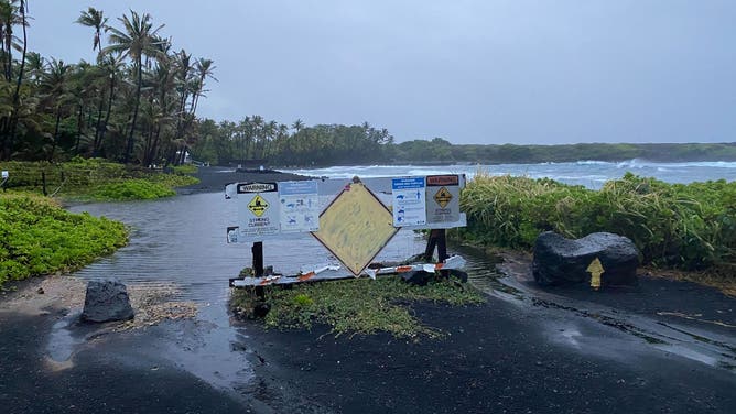 Rough surf created by Hurricane Hone passing south of the Big Island creates tide pools at Black Sand Beach in Punalu'u.