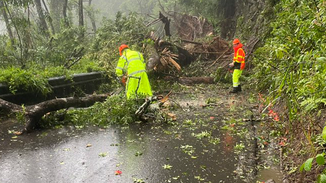 Hawaii Department of Transportation crews clear debris from a landslide on Hana Highway near Upper Waikani Falls on Maui on Aug. 25, 2024.