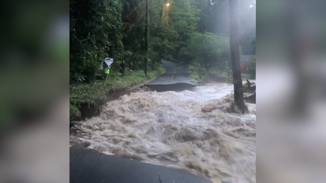 Floods destroy a road in Connecticut.