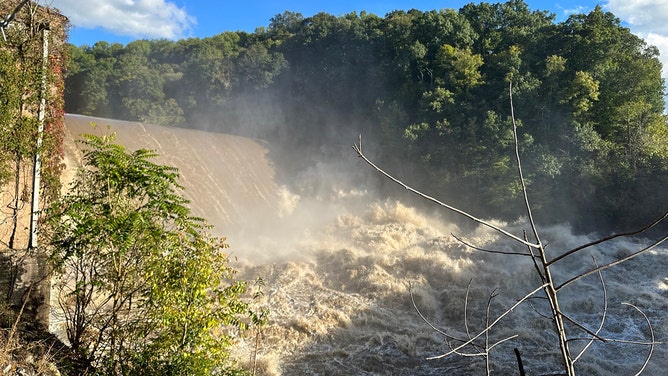 Waves of raging river water were seen crashing over the Nolichucky Dam in Tennessee as authorities feared its 