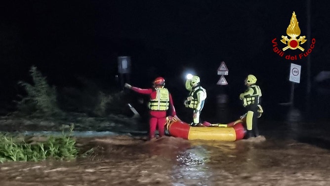 Aerials show flooded area as search goes on for two missing in Tuscany.