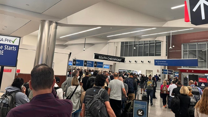 Lines begin to form at Atlanta Hartsfield-Jackson International Airport on Thursday as travelers prepare for security screenings.