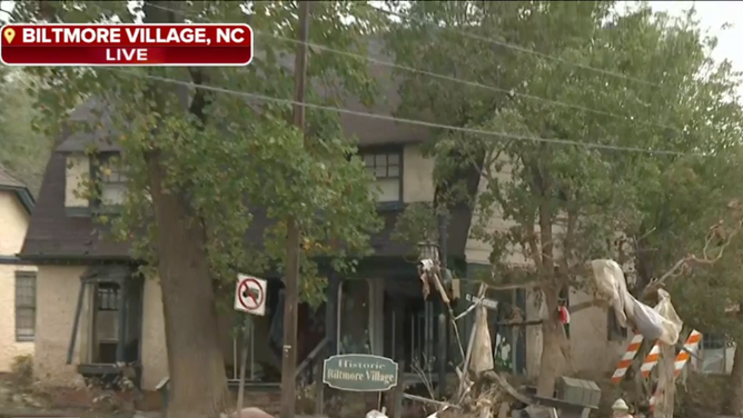 In a video shown during Kiyana Lewis' live report on FOX Weather, the historic Biltmore Village sign is seen covered by debris.