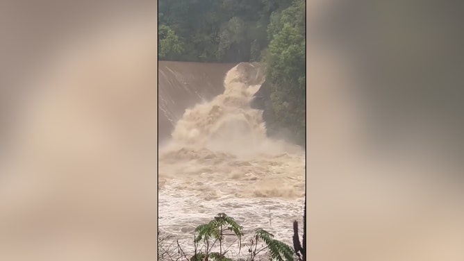 Waves of raging river water were seen crashing over the Nolichucky Dam in Tennessee as authorities feared its 